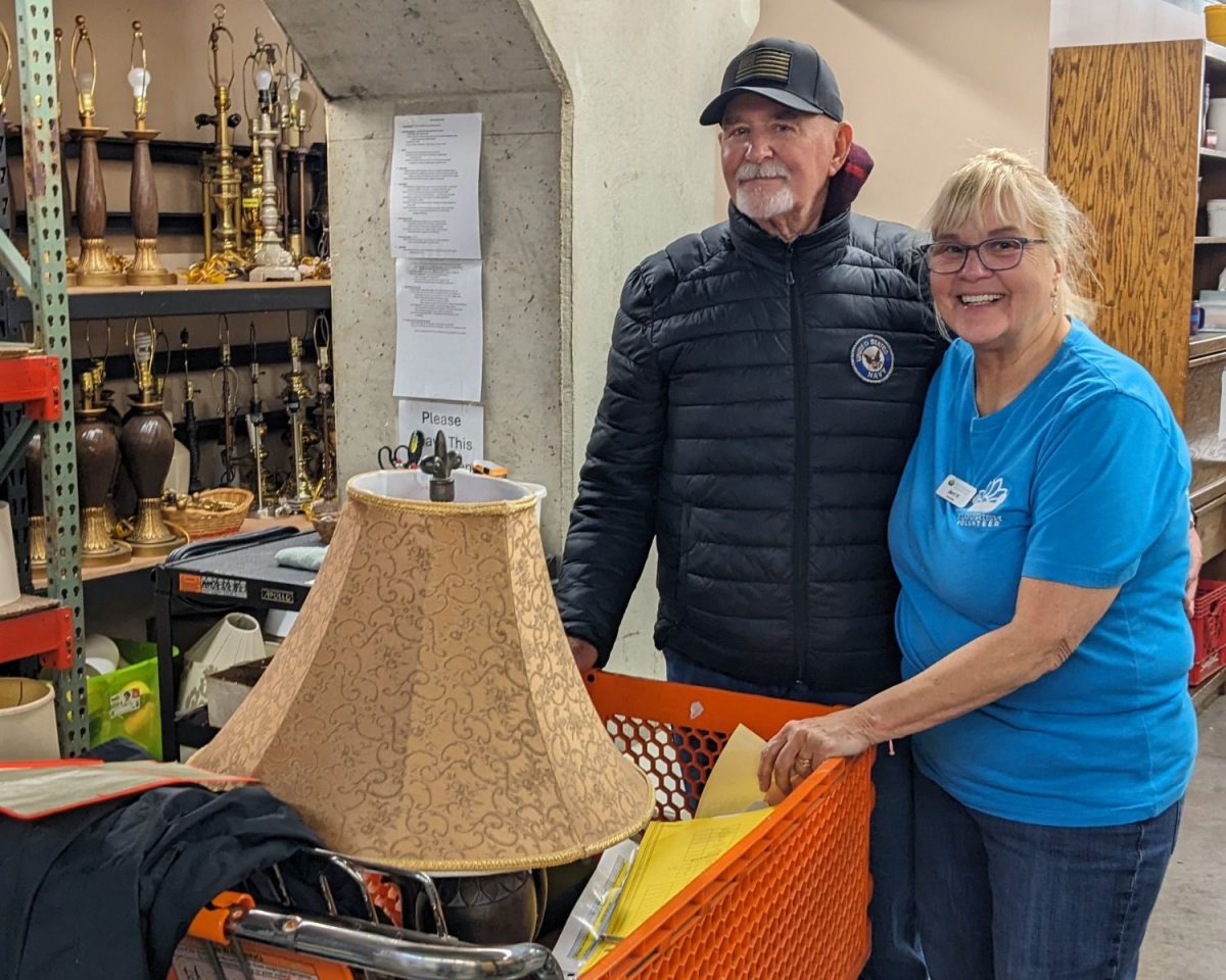 Jerry, guest, and Jerri, Flourish volunteer, shop for lamps