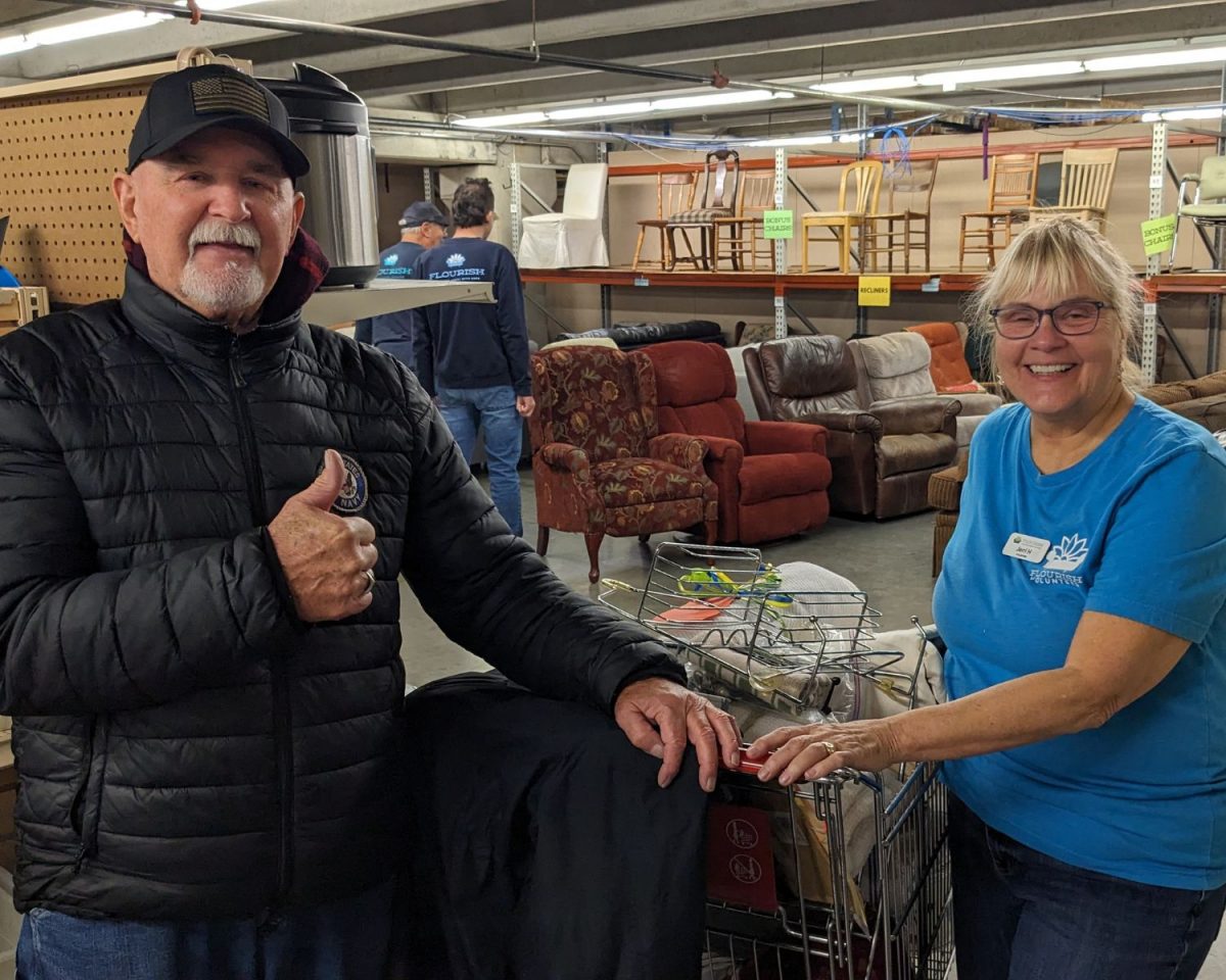 Jerry, guest, and Jerri, Flourish volunteer, shop for dining room tables